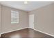 Simple bedroom with dark laminate wood flooring at 8795 Ribault Ave, Orlando, FL 32832