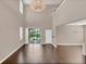 Spacious great room with high ceilings, chandelier, and sliding glass doors leading to the backyard at 8795 Ribault Ave, Orlando, FL 32832