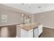 Modern kitchen with white cabinets, granite countertops, and a large island at 8795 Ribault Ave, Orlando, FL 32832