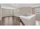 Open living area with hardwood floors and two chandeliers at 8795 Ribault Ave, Orlando, FL 32832