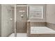 Bathroom features a shower and bathtub with tile surround at 8795 Ribault Ave, Orlando, FL 32832