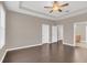 Spacious bedroom with dark laminate wood flooring and ceiling fan at 8795 Ribault Ave, Orlando, FL 32832