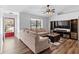 Bright living room with vaulted ceiling, L-shaped sofa and entertainment center at 2500 Cherry Blossom Ct, Eustis, FL 32726