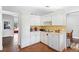 White kitchen with ample cabinet space, tiled backsplash and modern appliances at 2500 Cherry Blossom Ct, Eustis, FL 32726