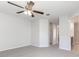 Bright bedroom with ceiling fan and access to bathroom and closet at 207 Goldenrod Ln, Kissimmee, FL 34759