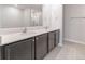 Double vanity bathroom with dark brown cabinets and white countertop at 207 Goldenrod Ln, Kissimmee, FL 34759