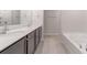 Bathroom boasts double vanity, soaking tub, and separate shower at 207 Goldenrod Ln, Kissimmee, FL 34759