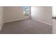 Well-lit bedroom featuring carpet and large window at 207 Goldenrod Ln, Kissimmee, FL 34759