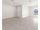 Bright living room with tile floors and access to backyard at 207 Goldenrod Ln, Kissimmee, FL 34759