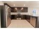Modern kitchen, stainless steel appliances and dark brown cabinets at 207 Goldenrod Ln, Kissimmee, FL 34759