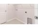 Bright laundry room with built-in shelving and tile flooring at 207 Goldenrod Ln, Kissimmee, FL 34759