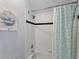 Bathroom with shower/tub combo and teal shower curtain at 558 Cadiz Loop, Davenport, FL 33837