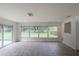 Bright sunroom features tile flooring and large windows offering a view of the backyard at 7129 Oakwind Dr, Orlando, FL 32818