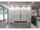 Kitchen features white cabinets and built-in refrigerator at 7129 Oakwind Dr, Orlando, FL 32818