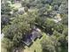 Aerial view of a ranch house on a tree-lined property at 7129 Oakwind Dr, Orlando, FL 32818