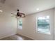 Bright bedroom with tile floors and ceiling fan at 7129 Oakwind Dr, Orlando, FL 32818