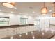 White kitchen with granite countertops and pendant lighting at 7129 Oakwind Dr, Orlando, FL 32818