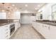 Modern kitchen with long granite island and stainless steel appliances at 7129 Oakwind Dr, Orlando, FL 32818