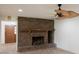 Living room with a brick fireplace and ceiling fan at 7129 Oakwind Dr, Orlando, FL 32818