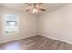 Simple bedroom with vinyl plank flooring and a window at 231 Begonia Ln, Kissimmee, FL 34759