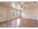 Bright living room featuring vinyl plank flooring and a ceiling fan at 231 Begonia Ln, Kissimmee, FL 34759