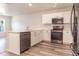Modern kitchen with white cabinets and stainless steel appliances at 231 Begonia Ln, Kissimmee, FL 34759