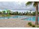 Large community pool with water features and lounge chairs at 11807 Fiction Ave, Orlando, FL 32832