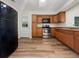 Updated kitchen with stainless steel appliances and wood cabinets at 908 Perkins St, Leesburg, FL 34748