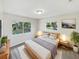Main bedroom with a plush bed and calming decor at 908 Perkins St, Leesburg, FL 34748