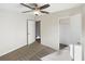 Well-lit bedroom with ceiling fan and built-in closet at 908 Perkins St, Leesburg, FL 34748