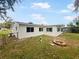 Rear view of the house with a firepit in the backyard at 908 Perkins St, Leesburg, FL 34748