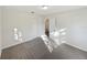Bright bedroom with carpet flooring and access to another room at 908 Perkins St, Leesburg, FL 34748