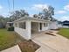 House exterior showcasing a covered entryway and landscaping at 908 Perkins St, Leesburg, FL 34748