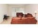 Living room with brown leather furniture and sliding glass doors at 8533 Greenbank Blvd, Windermere, FL 34786