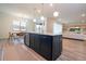 Open kitchen with island, stainless steel appliances, and view of living and dining areas at 5653 Oak Knoll Dr, St Cloud, FL 34771
