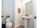 Small powder room with pedestal sink and wood-look tile floor at 5653 Oak Knoll Dr, St Cloud, FL 34771