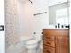 Simple bathroom with a shower/tub combo and wood vanity at 5653 Oak Knoll Dr, Saint Cloud, FL 34771