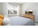 Bright bedroom with large window, dresser, and comfortable bed at 5653 Oak Knoll Dr, St Cloud, FL 34771