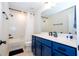 Modern bathroom with blue vanity and white subway tile at 5653 Oak Knoll Dr, St Cloud, FL 34771