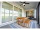 Screened patio with wooden table and chairs, and string lights at 5653 Oak Knoll Dr, St Cloud, FL 34771