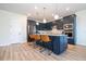 Modern kitchen featuring dark blue cabinets, stainless steel appliances, and a breakfast bar at 5653 Oak Knoll Dr, Saint Cloud, FL 34771