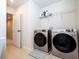 Bright laundry room with washer, dryer, and ample shelving at 5653 Oak Knoll Dr, Saint Cloud, FL 34771