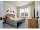 Bedroom with a metal bed frame, tv, and window at 5653 Oak Knoll Dr, St Cloud, FL 34771