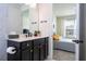 Clean bathroom with dark vanity and bedroom view at 5653 Oak Knoll Dr, St Cloud, FL 34771