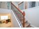Elegant staircase with wrought iron railings and wooden handrail at 5653 Oak Knoll Dr, St Cloud, FL 34771
