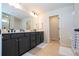 Elegant bathroom with double vanity, modern fixtures, and a large mirror at 5653 Oak Knoll Dr, St Cloud, FL 34771