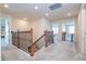 Upstairs hallway with carpet flooring and access to bedrooms at 5653 Oak Knoll Dr, St Cloud, FL 34771