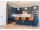 Modern kitchen with dark blue cabinetry, stainless steel appliances, and an island with seating at 5653 Oak Knoll Dr, St Cloud, FL 34771