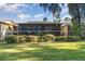 Rear view of condo building with screened porch at 120 Hibiscus Woods Ct # 8D, Deltona, FL 32725