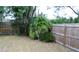 Fenced backyard with lush greenery and mature trees at 4663 Montauk St, Orlando, FL 32808